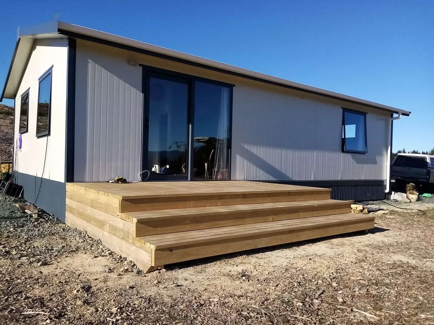 A new timber deck and steps built onto a modern Tasman home
