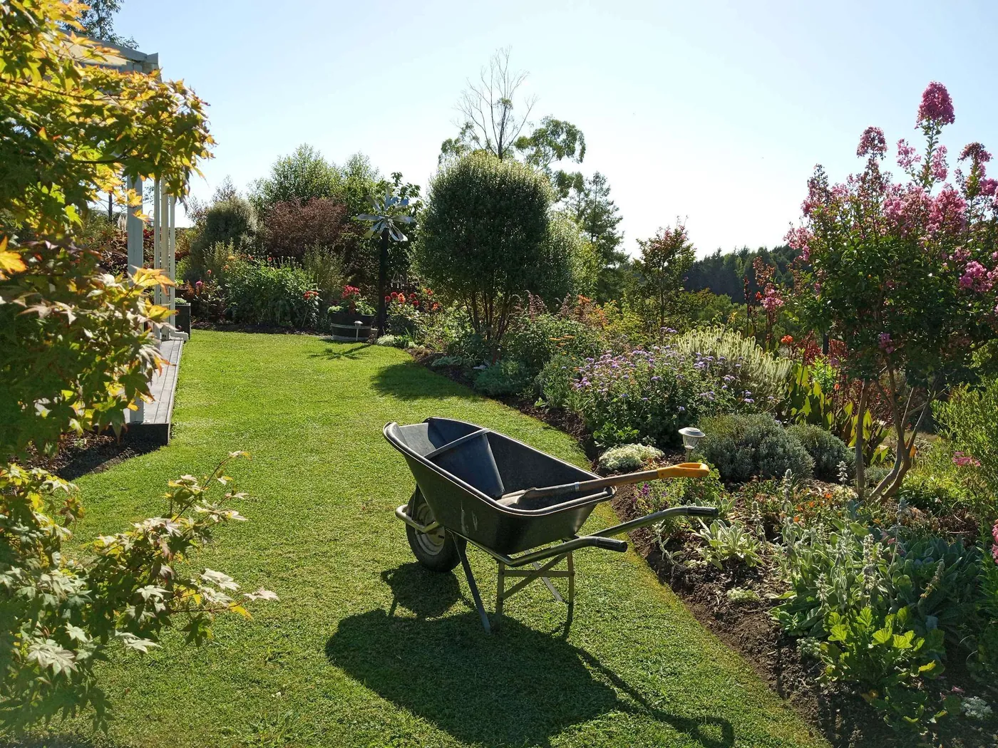 A tidied garden bed and freshly mown lawn at a Tasman property