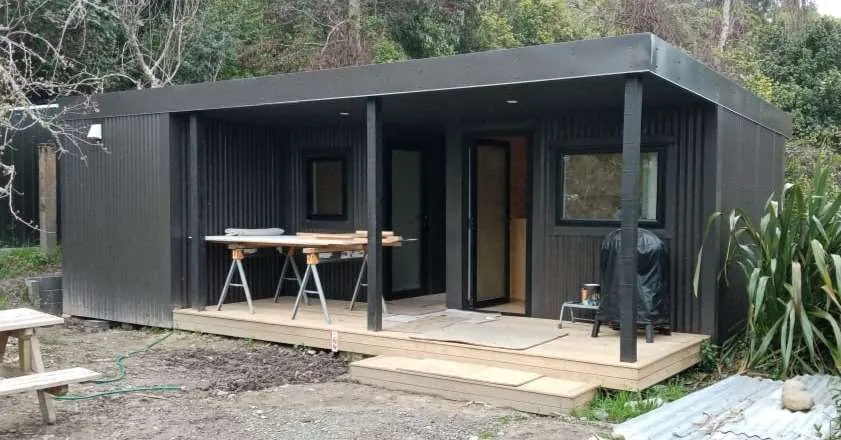 Dark-clad garden office pod with timber decking