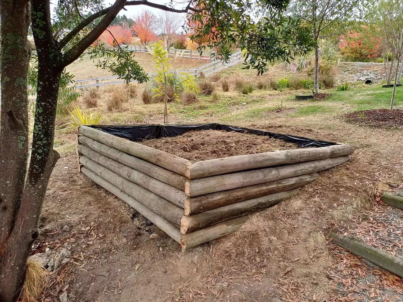Timber raised garden bed built into a sloping section