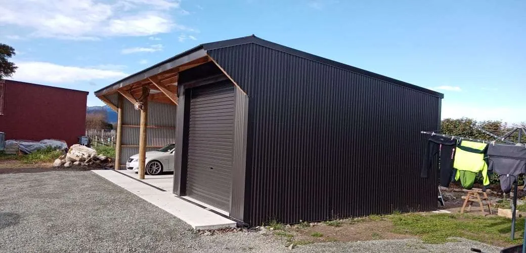 Dark-clad farm shed and garage build on a rural section